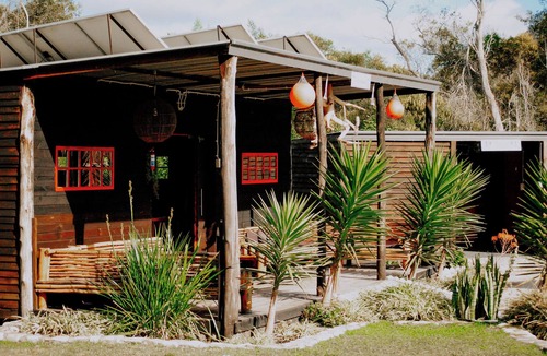 Pearly Beach RV Rental | Flow @ Tides Glamping is a secluded glamping retreat surrounded by trees.
